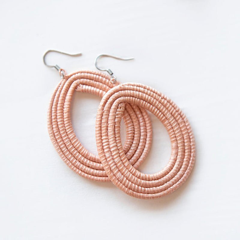 Hand-Woven Loop Earrings in soft pink, showcasing artisan craftsmanship with a modern design.